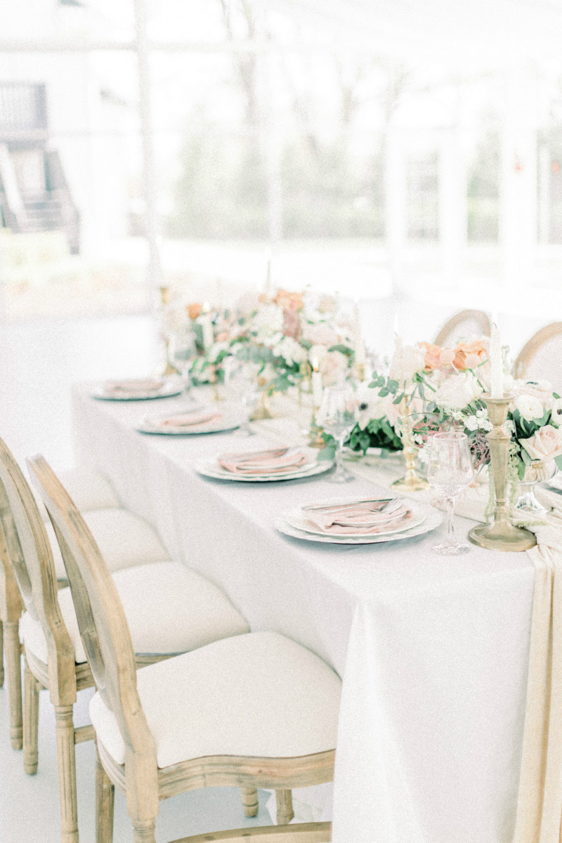 white and peach table with wood chairs